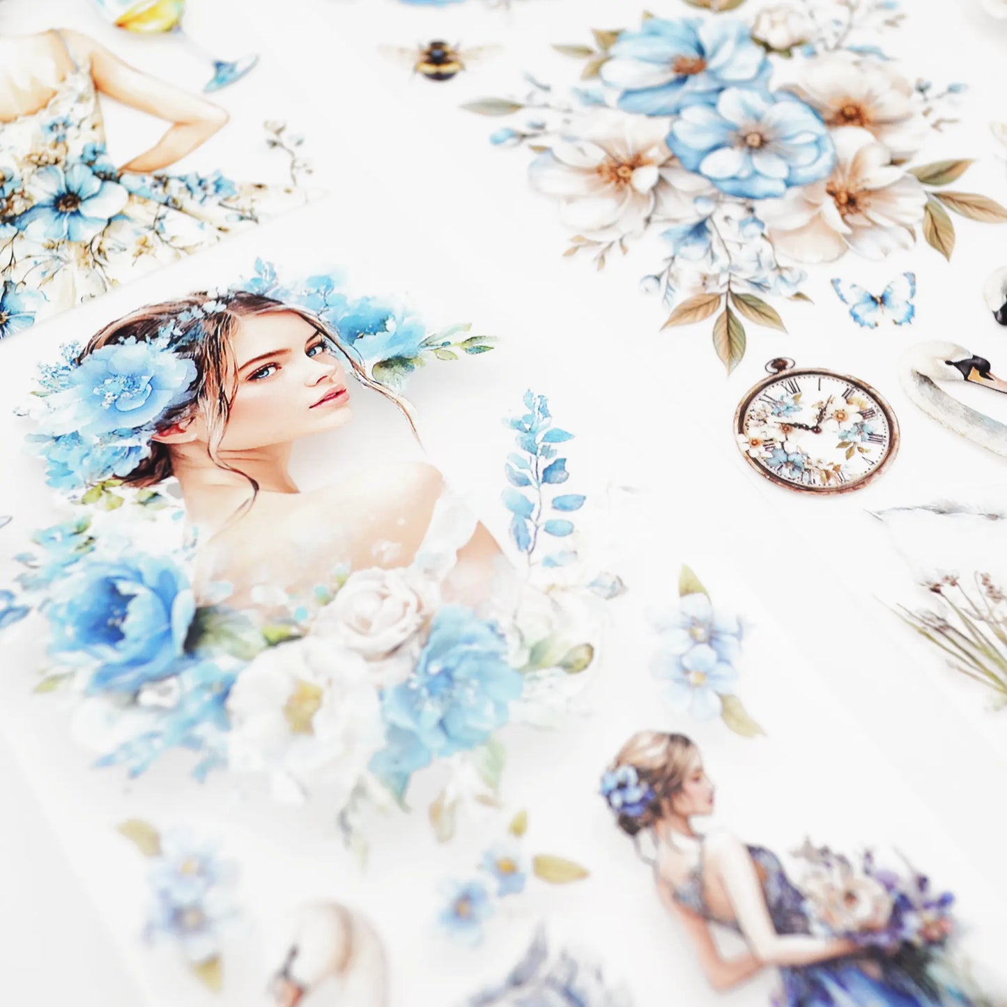 A roll of decorative PET tape stickers with a vintage romantic theme in baby blue and white colours, featuring illustrations of women in floral dresses, swans, butterflies, pocket watches, floral arrangements, hand bags, shoes, perfume bottles and more
