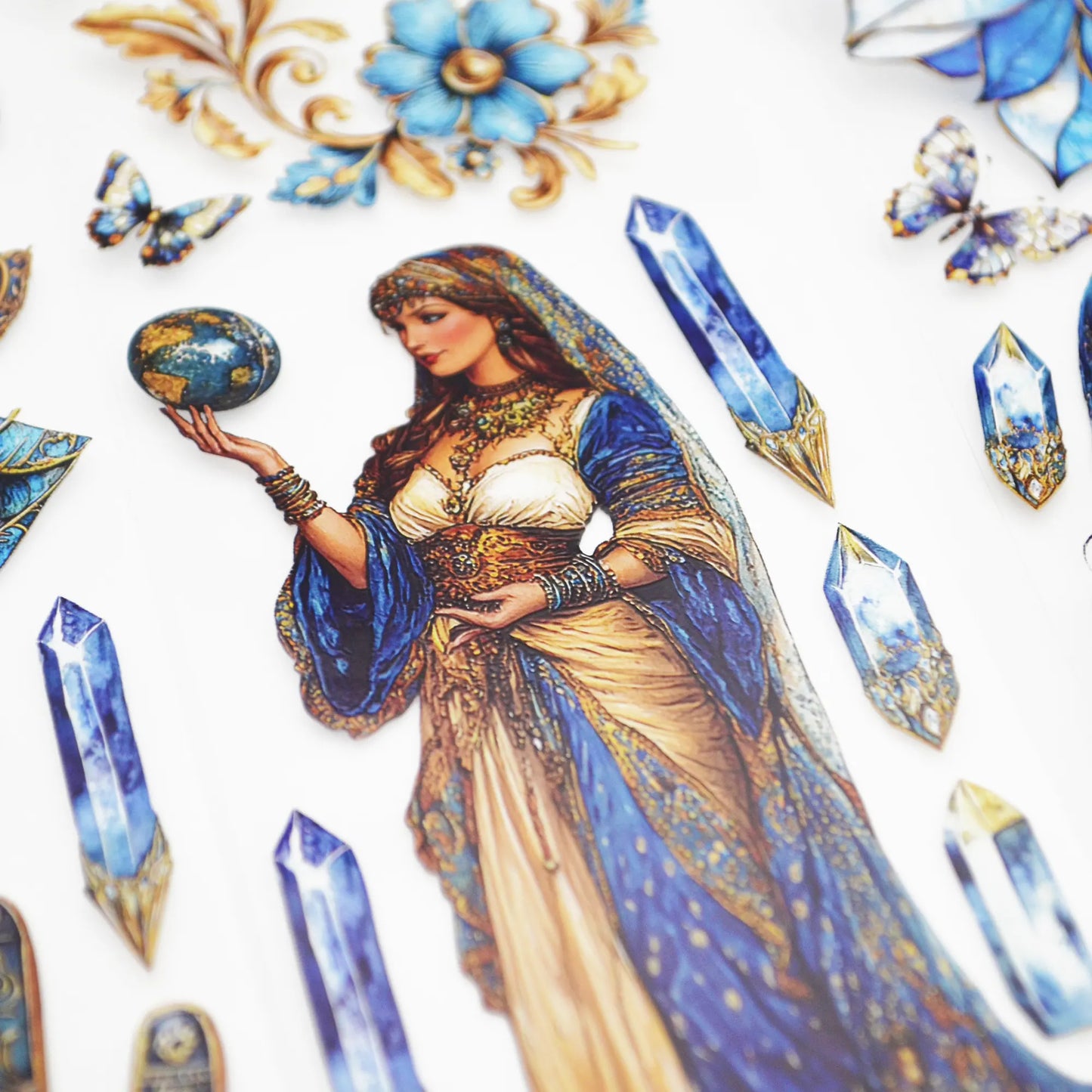 A roll of decorative PET tape stickers with a mystic fortune teller theme in blue and gold colours, featuring illustrations of the fortune teller, crystal balls, palmistry, decorative stained glass flowers, crystal geodes and more