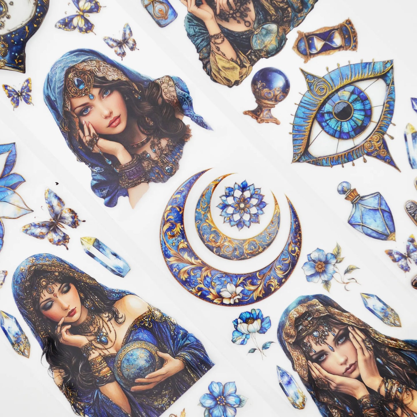 A roll of decorative PET tape stickers with a mystic fortune teller theme in blue and gold colours, featuring illustrations of the fortune teller, crystal balls, palmistry, decorative stained glass flowers, crystal geodes and more