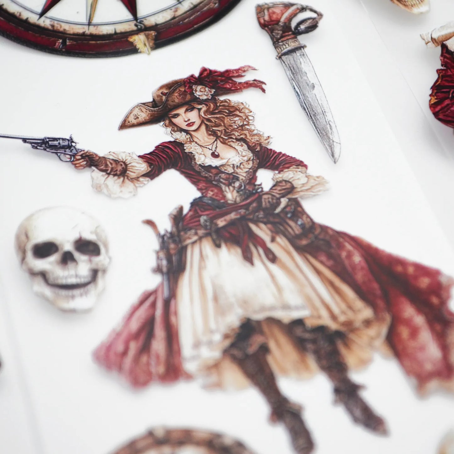 A roll of decorative PET tape stickers with a fantasy pirate theme in red and cream colours, featuring illustrations of pirate crew members, gold and treasure chests, compass and maps, bottles of rum and more