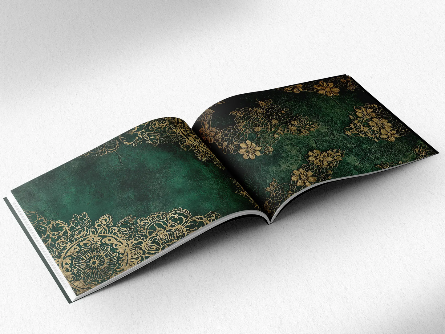 open book displaying the inner pages of a decorative paper prints pad showing green doilie lace patterns
