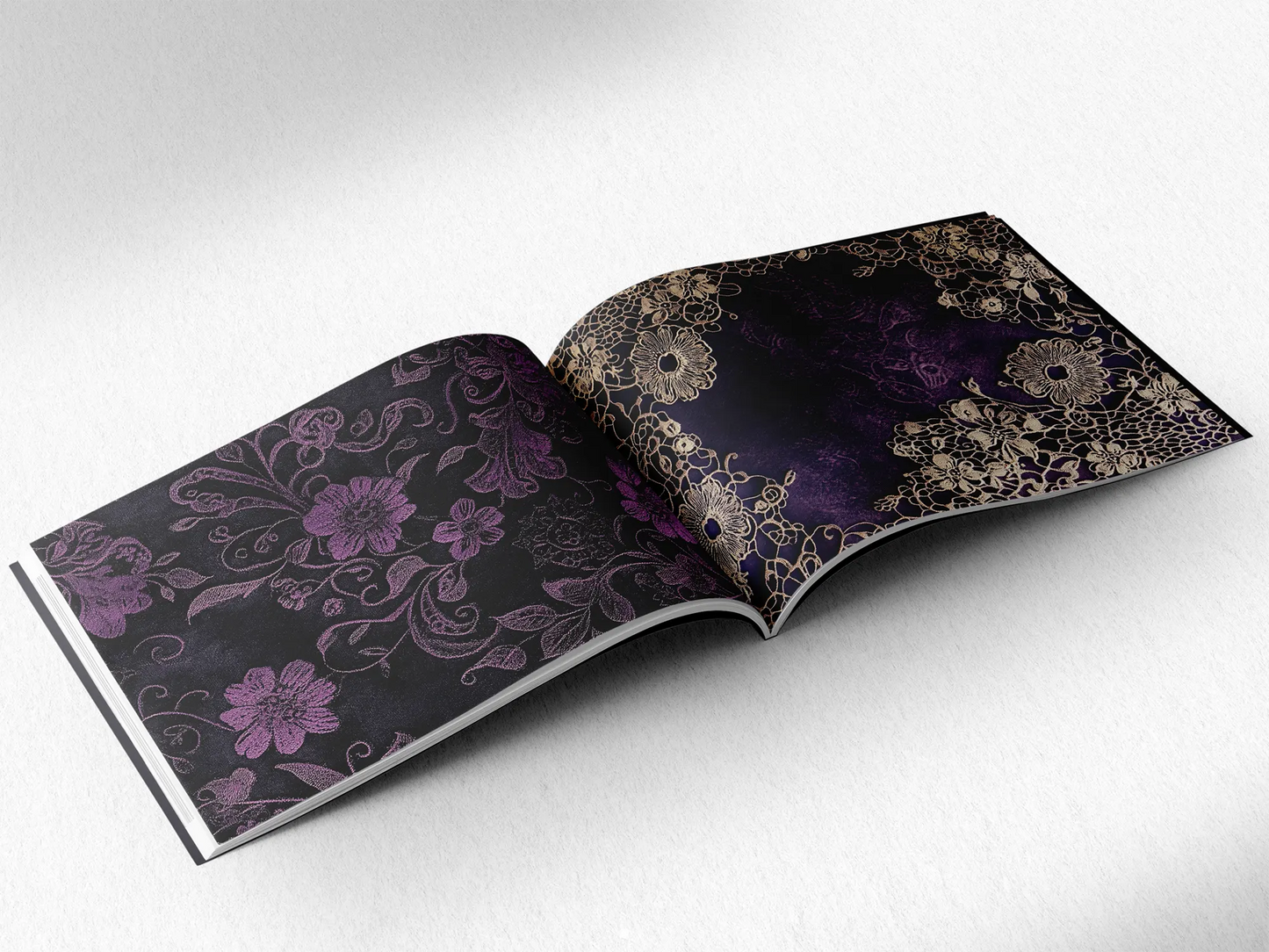 open book displaying the inner pages of a decorative paper prints pad showing purple doilie lace patterns