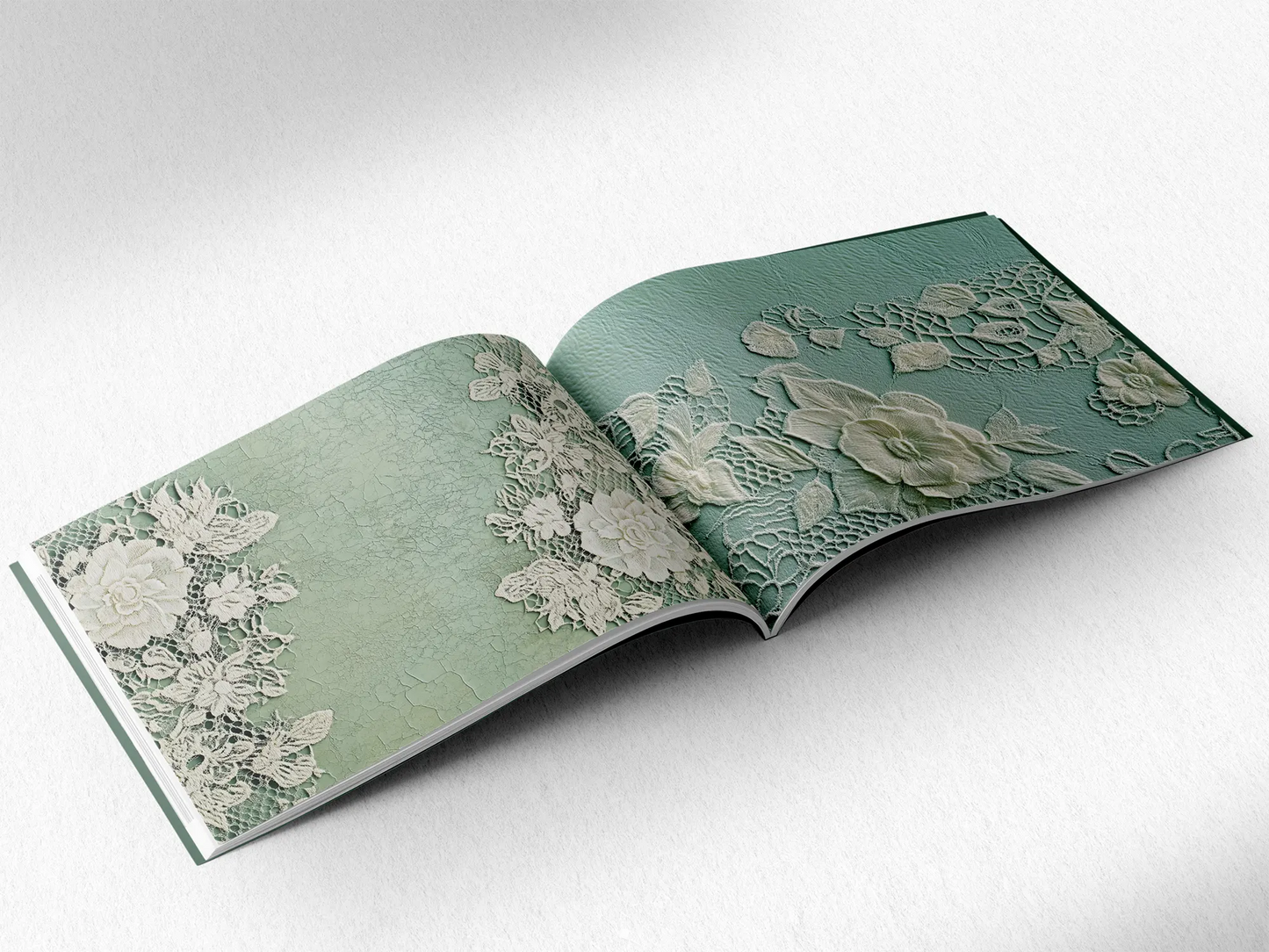 open book displaying the inner pages of a decorative paper prints pad showing green doilie lace patterns