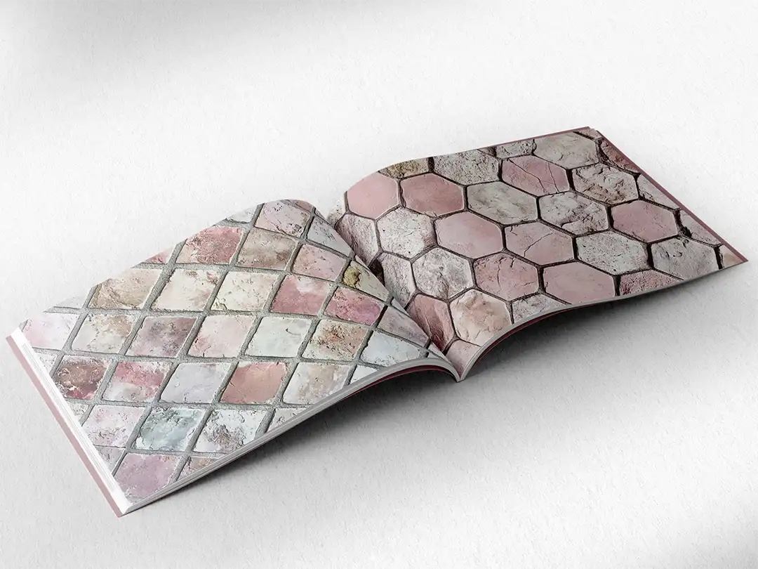 open book showing the inside pages of the decorative stone textures prints pad. The picture inside the book is a pink stone texture