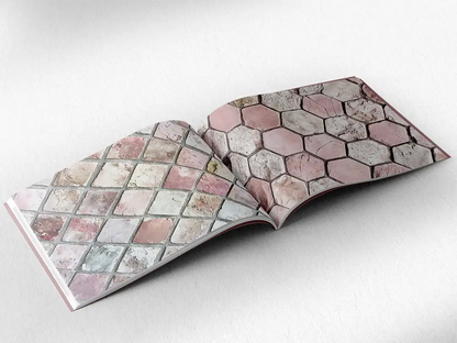 open book showing the inside pages of the decorative stone textures prints pad. The picture inside the book is a pink stone texture